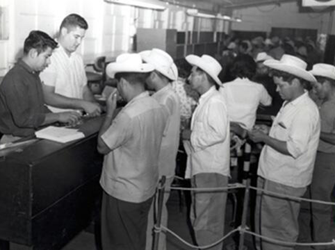 Image of INS employees Rogelio De La Rosa (left) and Richard Ruiz (right) provided forms and instructions.